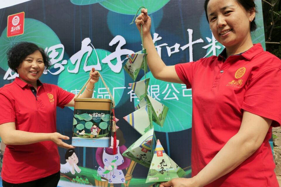 發(fā)布會現(xiàn)場大家爭相與“九子荷葉粽”合影